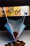 The economic effect of the pandemic - A 50 euro banknote holds up a protective mask filled with euro cents, concept