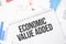 economic value added text on paper on the chart background with pen