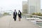 economists male and female in strict suits walking.