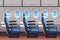 Economy class airliner seats row with portholes