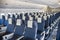 An economy class empty cabin of the airplane - empty dark blue chairs