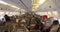 Economy class passengers take their seats and get ready for the takeoff in the cabin of a Boeing 767 - 300 airplane