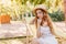 Ecstatic long-haired woman with elegant make-up enjoys good sunny morning while sitting in garden chair. Outdoor