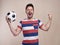 Ecstatic male fan with soccer ball cheering