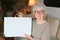 Ecstatic senior woman holding a briefcase