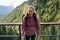 Ecstatic woman thrilled with the view of a mountain slope covered with forest