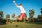 Ecstatic young casual man jumping of joy outside