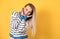 Ecstatic young women, isolated on yellow background. Gorgeous girl wears sweater