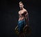 Ectomorph shirtless athletic male holds barbell weight.