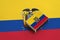 Ecuador flag is pictured on a matchbox that lies on a large flag