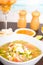 Ecuadorian ceviche served on a white dish selective focus, behind salt and pepper