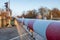 ed and white level crossing railway barrier covered with frost which block the road on countryside.