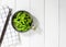 Edamame nibbles, boiled green soy beans, japanese food, Top view on white wooden table