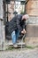 Ederly man in protective mask with a cane descends down the stairs