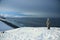 On the edge of the earth, north of Russia, the Arctic Ocean shore. Contrast of overall nature and small man. Beautiful snowy view