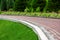 The edge of the footpath reinforced by a stone curb.