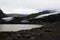 The Edge Of a Glacier Meets Lake Of Run-Off Water