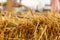 The edge of a haystack. Rural farm background, copy space. Yellow bright sunny cereal straw