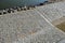 Edge of the river bank reinforced with giant stones as a breakwater against erosion of stone paving at the dock cobblestone promen