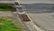 At the edge of the road is a concrete trough for collecting rainwater. for cars and cyclists to cross this drainage gutter with th