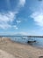 the edge of sanur beach with views of mount agung and traditional boats made of wood