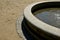 Edge of a stone sandstone circular fountain in the park. built of sandstone filled with water. lined with a light threshing gravel