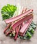 Edible rhubarb stalks on the wooden table.