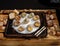 edible snails with stuffing on a wooden tray on salt. Blur and selective focus. Beautiful presentation of the dish.