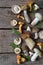 Edible wild white mushrooms, boletus, russule, chanterelles on the wooden background.