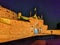 Edinburgh castle at night with the historic red Lion rampant crest - Translation of the latin Nemo me impune lacessit