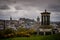 Edinburgh City and Castle, Scotland, viewed from Calton Hill on a cloudy afternoon with the Dugald Stewart monument in