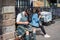 Edinburgh, Scotland, August 18th 2019. A young man dressed in national Scottish clothes and a kilt uses a smartphone sitting on a