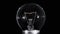 Edison lamp light bulb blinking over black, macro view, looped