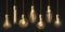 Edison light bulbs. Hanging vintage pendant copper lamps with glowing lightbulb filament. 3d decorative bulb on