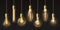 Edison light bulbs. Hanging vintage pendant copper lamps with glowing lightbulb filament. 3d decorative bulb on electricity wire