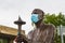 Editorial, bronze statue wearing surgical mask