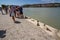 Editorial, holocaust memorial Shoes on the Danube Bank, overlooking river with tourists landscape, Budapest