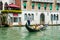 Editorial. May 2019. Venice, Italy. Gondolier driving the gondola with tourists on the Grand Canal in Venice in a sunny day