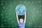 Educated school kid lifting world globe chalk doodle drawing on green chalkboard for education concept