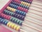 Education concept - abacus with many colorful beads. Red, blue, green, black, yellow details on the abacus. Mathematical exercises