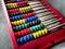 Education concept - abacus with many colorful beads. Red, blue, green, black, yellow details on the abacus. Mathematical exercises
