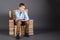 Education concept. A boy sits on a throne of books