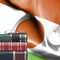 Education concept - Stack of books and reading glasses against National flag of Niger