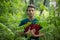 Education concept - teenager is holding a book in his hands in nature