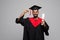 education, graduation and people concept - happy smiling indian male graduate student in mortar board and bachelor gown with