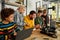 Education is the most powerful tool. Group of smart kids with their male teacher looking at 3d printer and plastic