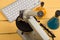 Education and science concept - microscope, computer keyboard, eyeglasses and chemical liquids on the yellow desk in the auditoriu