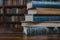 Education setup stack of books on a wooden table in library