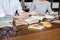 Education, teaching, learning concept. Two high school students or classmates group sitting in library with helps friend doing