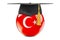 Education in Turkey concept. Turkish flag with graduation cap, 3D rendering